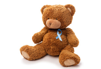 medicine, healthcare and oncology concept - teddy bear toy with blue prostate cancer awareness ribbon on white background