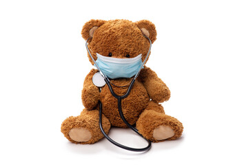 medicine, healthcare and pandemic concept - teddy bear toy in protective medical mask with...