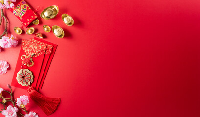 Chinese new year decorations made from red packet, orange and gold ingots or golden lump on a red...