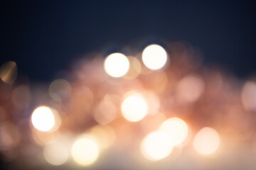 Fototapeta premium Blurred Christmas lights over dark blue background