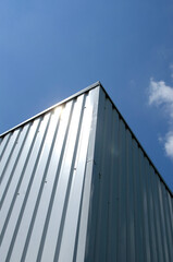 Fototapeta na wymiar Corner of metal container against sky