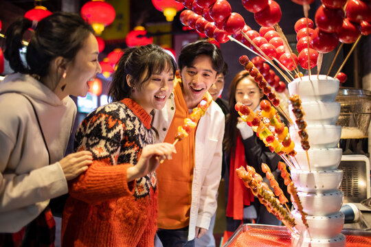 Young friends with candied haw celebrating Chinese New Year