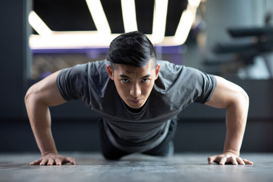Young man exercising at gym