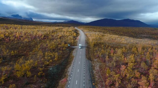 50fps drone footgage Car Camping Caravan driving road lake Swedish Lapland Sunny fall colors Abisko National Park Sweden
