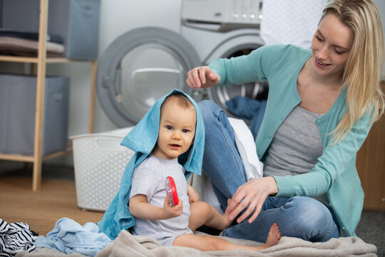 happy family mother housewife and child daughter in laundry