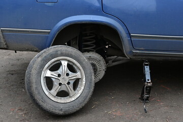 replacement of the rear wheel of a car. car repair at home. hole in the wheel.