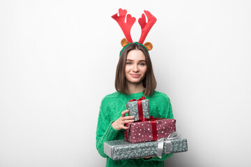Isolated young smiling girl holds red and green gifts