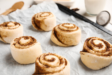 Baking dish with uncooked cinnamon rolls on table, closeup