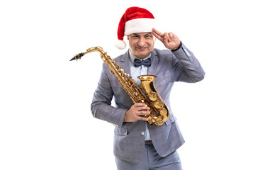Fototapeta na wymiar Funny Musician wears in Santa's hat holds saxophone while raising hand to head on studio background