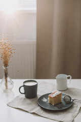 breakfast with a piece of fresh homemade cake, pitcher and cup of coffee on a table