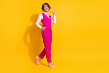 Fototapeta na wymiar Full length body size view of attractive cheerful businesswoman going waving hi isolated over bright yellow color background