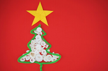 Christmas material with a red background, white cedar, with a golden five-pointed star. Christmas atmosphere.