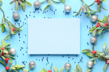Blank card and Christmas decor on blue background