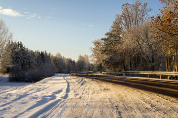 Beautiful empty winter snow road on a sunny cold day