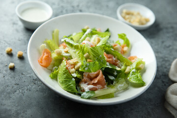 Traditional homemade Caesar salad with smoked salmon
