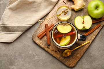 Fototapeta na wymiar Cup of tasty fruit tea with cinnamon on grey background