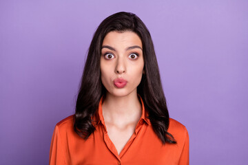 Portrait of attractive amazed girl wearing orange silk shirt stupor pout lips isolated over bright purple violet color background