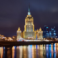 Fototapeta premium Christmas Moscow. New Year's decorations on Moscow embankment. Russian city in Christmas illumination. Moscow river on a winter night