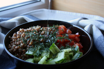 Salad of buckwheat, tomatoes, cucumbers and dill.