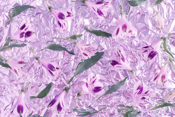 Flowers on Holographic Abstract lilac blue natural background. Hologram Foil Aesthetic, iridescent pattern. Trendy color very peri in the 2022 Year.