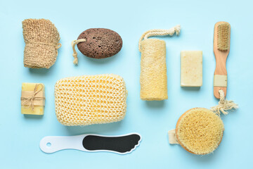 Different bath supplies for foot massage on blue background