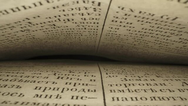 Close-up of the pages of an old book in Russian. Inside the book. Slider movement. 4k