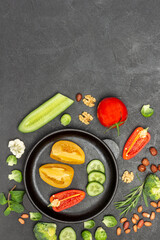 Chopped tomatoes, cucumbers and peppers in frying pan.