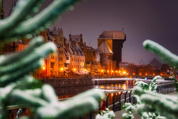 Beautiful architecture of the old town in Gdansk by the Motława river with a historic port crane...