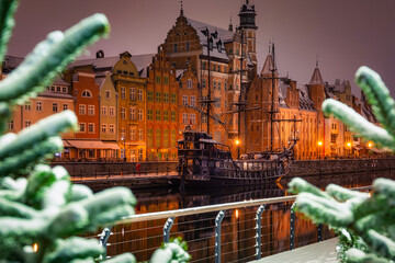 Beautiful architecture of the old town in Gdansk by the Motława river at wintery night. Poland