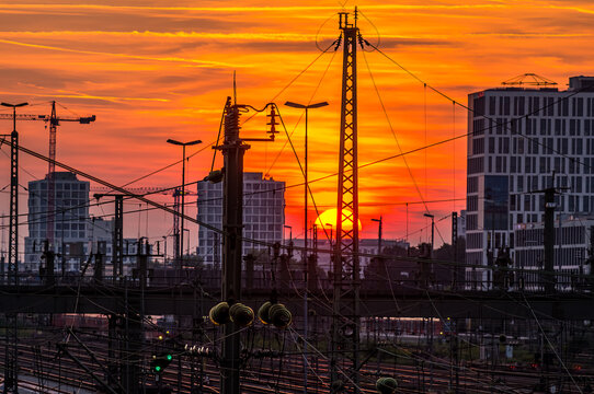 Munich at orange sunset, view over the railways towards the Donnersberger bridge