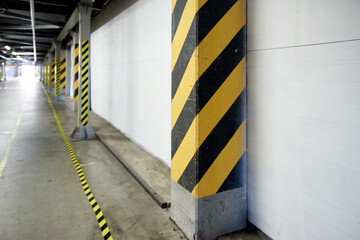 Column yellow - black in the warehouse, signal attention danger