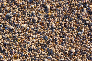 Mediterranean shoreline pebble beach. Stone nature background.