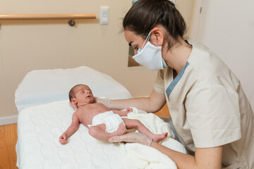 Physiotherapist performing craniosacral work on a newborn baby.