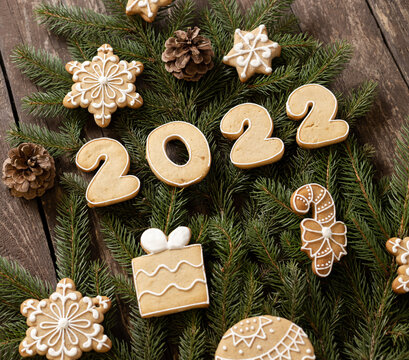 Winter Christmas home baked cookies decorating a Christmas tree on wooden background wishing you a happy New Year 2022
