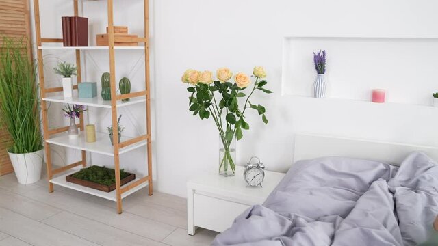 Nice lady lyaing silky soft bed awakening use device typing post in room