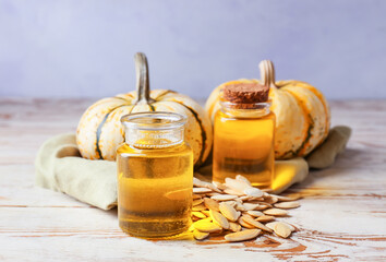 Obraz premium Bottles with pumpkin seed oil on table