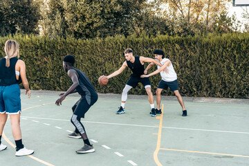 Friends playing basketball on a court