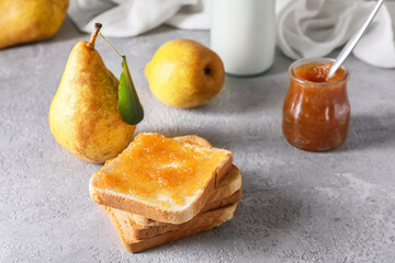 Bread with tasty pear jam on grey background