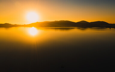 Practicing stand up pandle at sunrise at Lagoa da Conceição in Florianópolis Santa Catarina Brazil