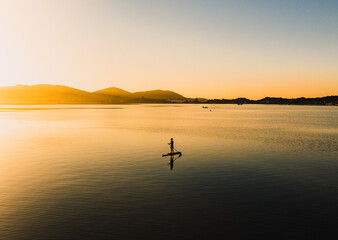 Practicing stand up pandle at sunrise at Lagoa da Conceição in Florianópolis Santa Catarina Brazil