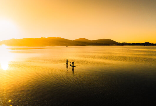 Practicing stand up pandle at sunrise at Lagoa da Concei&ccedil;&atilde;o in Florian&oacute;polis Santa Catarina Brazil