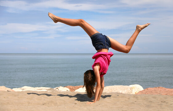 girls performing rhythmic gymnastics exercise called walkover