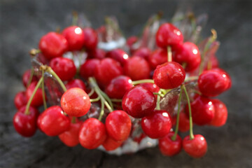 Red berries. Fresh red Sweet cherries on the wooden table. Red Cherries. Fresh ripe sour cherries in a wine glass. Food background. Red juicy Sweet cherries. Soft focus. Copy space. horizontal photo