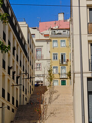 Fototapeta na wymiar Staircase and traditional houses on a hill slope of Lisbon