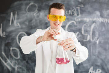 Chemist carries chemistry experiment in laboratory. Test-tubes with chemical reagent. Chemical...