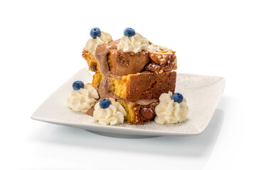 Panettone cake slices with Dulce de leche cream, whipped cream, blueberries and almonds. Italian...