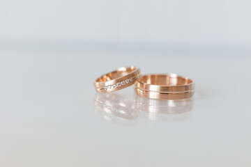 Two wedding rings on a glass background 