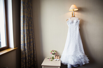 Wedding dress in a room. Bride's morning preparation