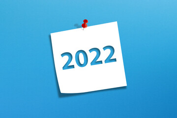 Note paper with Happy New Year 2022 on blue background