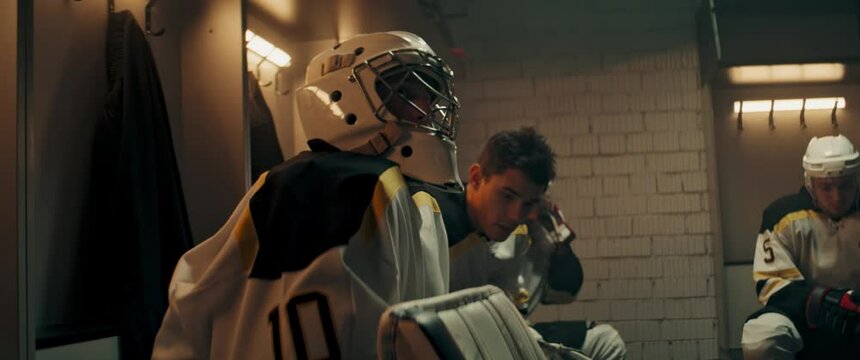 Teammates cheering up their goaltender in the locker room during the intermission. Shoot with 2x anamorphic lens